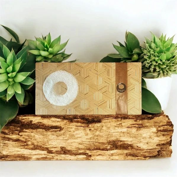 Rimming board for cocktail drinks with geometric patterns surrounded by green succulents.
