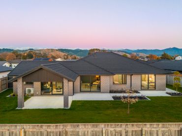 Modern single-story house with a spacious backyard and mountain views.
