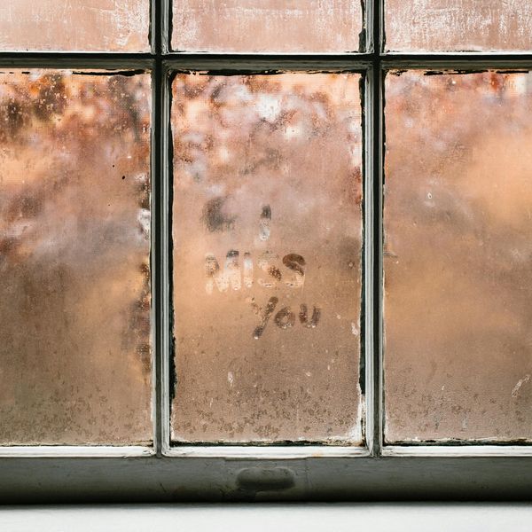 THE WORDS, "I MISS YOU," ETCHED ON A FOGGY WINDOW