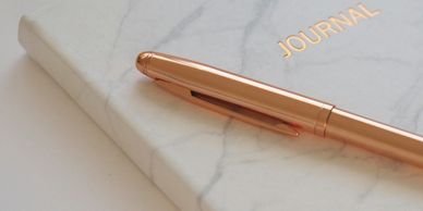 A journal and a pen for taking notes.