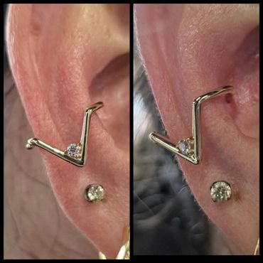 Close-up of a gold earring with a diamond on a person's ear.