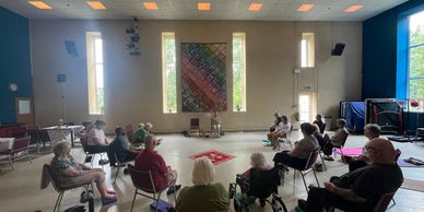 Group meeting in a spacious room with natural light.