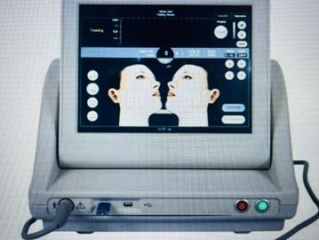 A medical device screen showing facial treatment options for two faces.