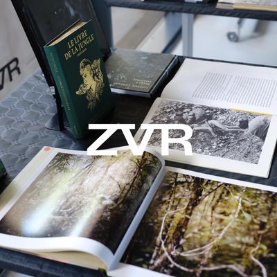 Books and magazines about nature and jungle displayed on a table.