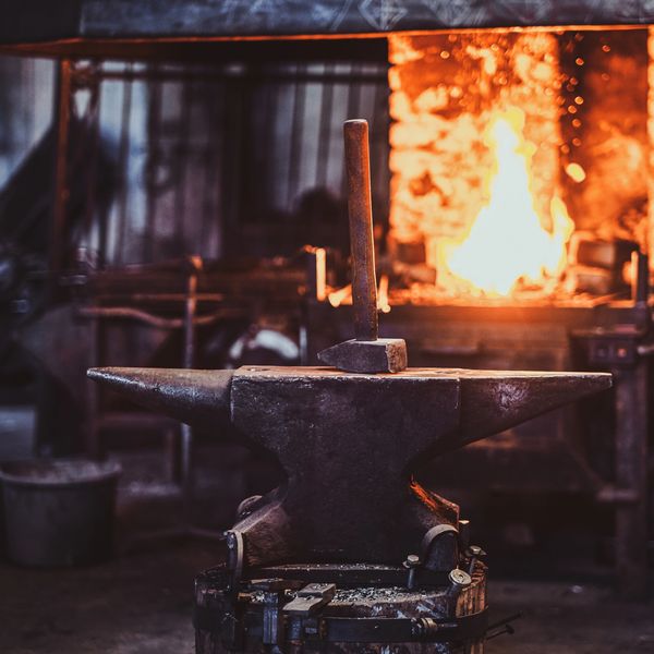 Blacksmith forge glowing with fire symbolizing transformation and craftsmanship.