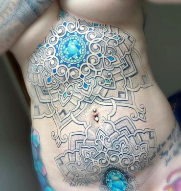 stomach sternum blue gem mandala dot work tattoo