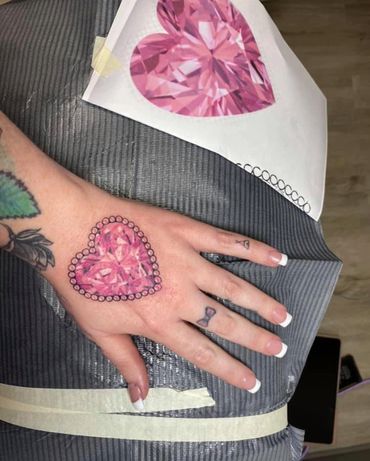 pink gem hand tattoo