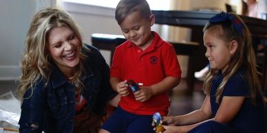 Child psychologist conducting play therapy session with young clients