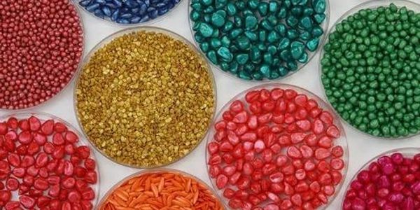 Colorful beads in round containers.