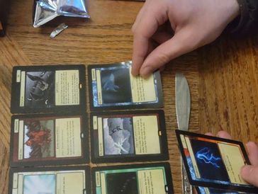 Opening a pack of the independent card game, Arcane: The Eternal.