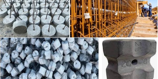 Various concrete cube test samples with steel rods and a metal test weight.