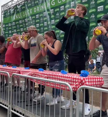 Jalen Franko competing in a pickle juice chugging competition at Picklesburgh in Pittsburgh, PA.