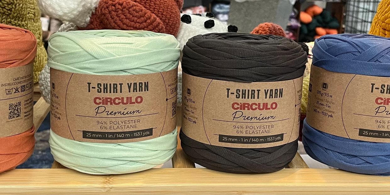 Three rolls of CIRCULO T-shirt yarn in different colors.