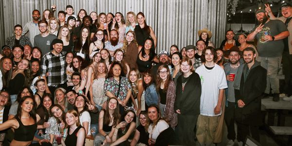 Large group of people posing together indoors.