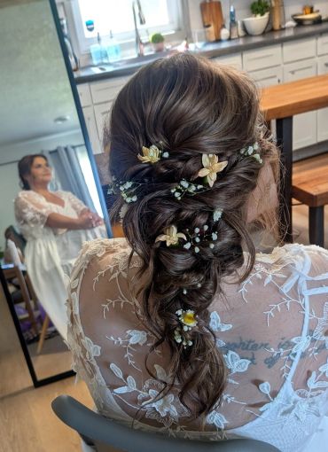 Intricate bridal hairstyle with floral adornments.