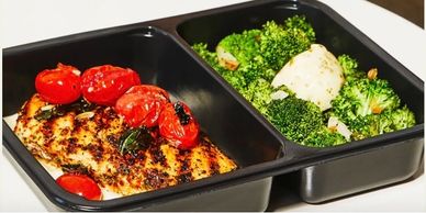 Grilled chicken with roasted tomatoes and steamed broccoli side.