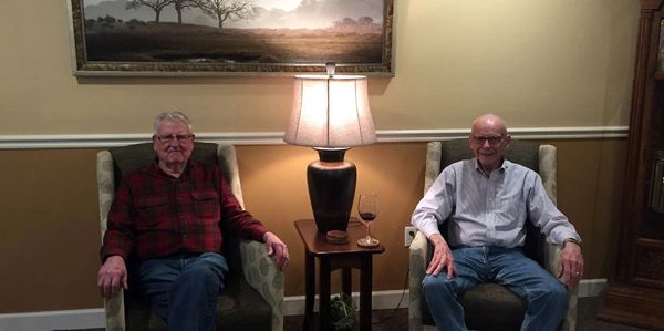 Two gentlemen residents relaxing in the common area living room.