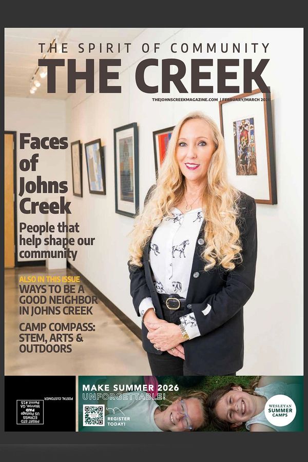 Cover of The Creek magazine featuring a woman in an art gallery.