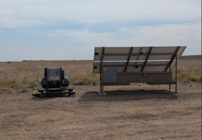 Solar panel and equipment in a dry field.