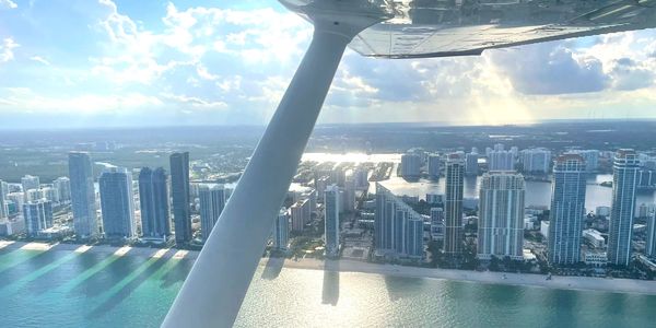 A photo of Miami coastline captured from the air, under the wing of a Cessna 172.