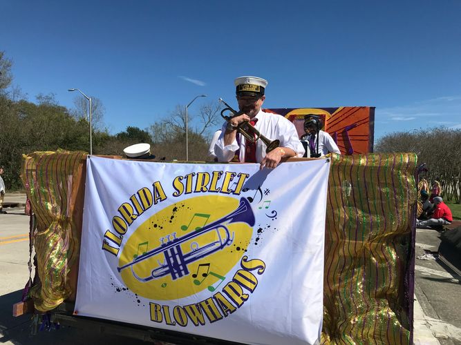 Sam Irwin of the Florida Street Blowhards on the band Mardi Gras float.