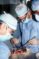 Cardiac Bypass Operation with Surgeon holding Instruments