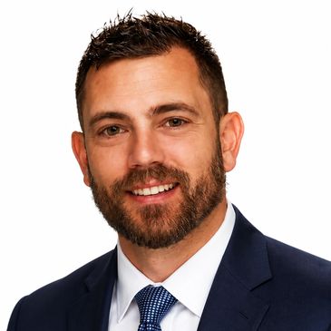 Professional headshot of a man in a suit.