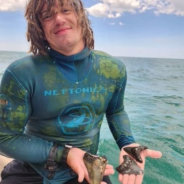 Landon, owner of The Florida Sharktooth Company with some megalodon shark teeth!