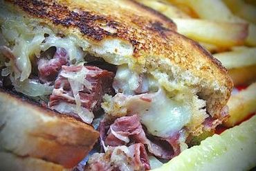 A slice of bread sandwich stuffed with meat and cheese 
