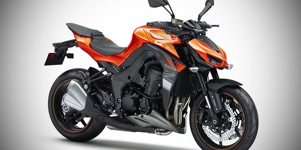 Sleek orange and black Kawasaki motorcycle with modern design and sporty features.