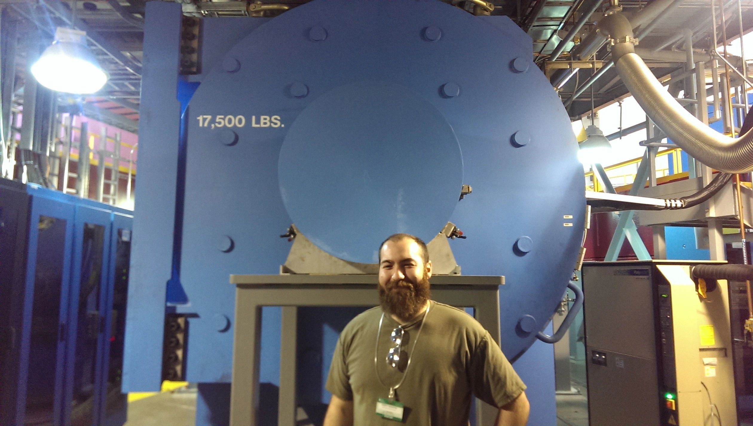 Dr BoK standing informs of an enormous vacuum at Oakridge National laboratories 