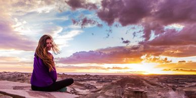 Woman sitting and observing the sunrise