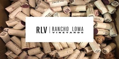 Rancho Loma Vineyards logo with wine corks.