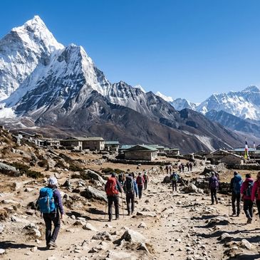 Hikers trekking towards snow-capped mountains in a remote valley.