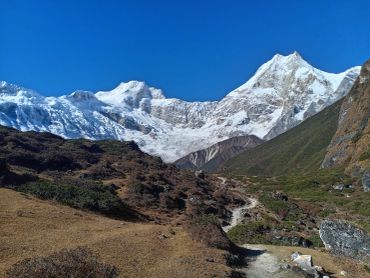 Snow-covered mountain under a clear blue sky.