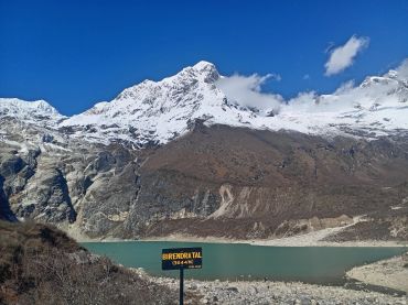 Snowy mountain and turquoise lake at Birendra Tal, Nepal.