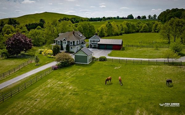 Drone photograph of farmhouse with horses in PA, taken by Fox Creek Aerial Productions.