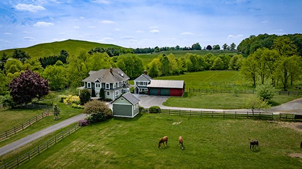 Aerial photo by Fox Creek Aerial Productions of a farm house with three horses in the foreground.