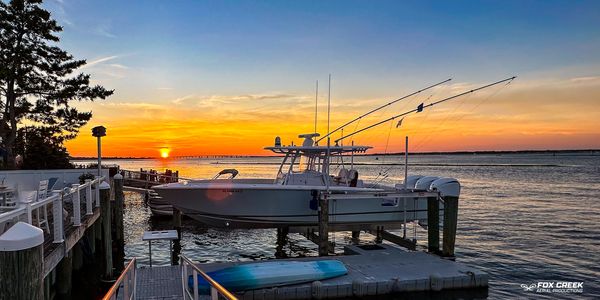 Boat with sunset in background taken with drone by Fox Creek Aerial Productions