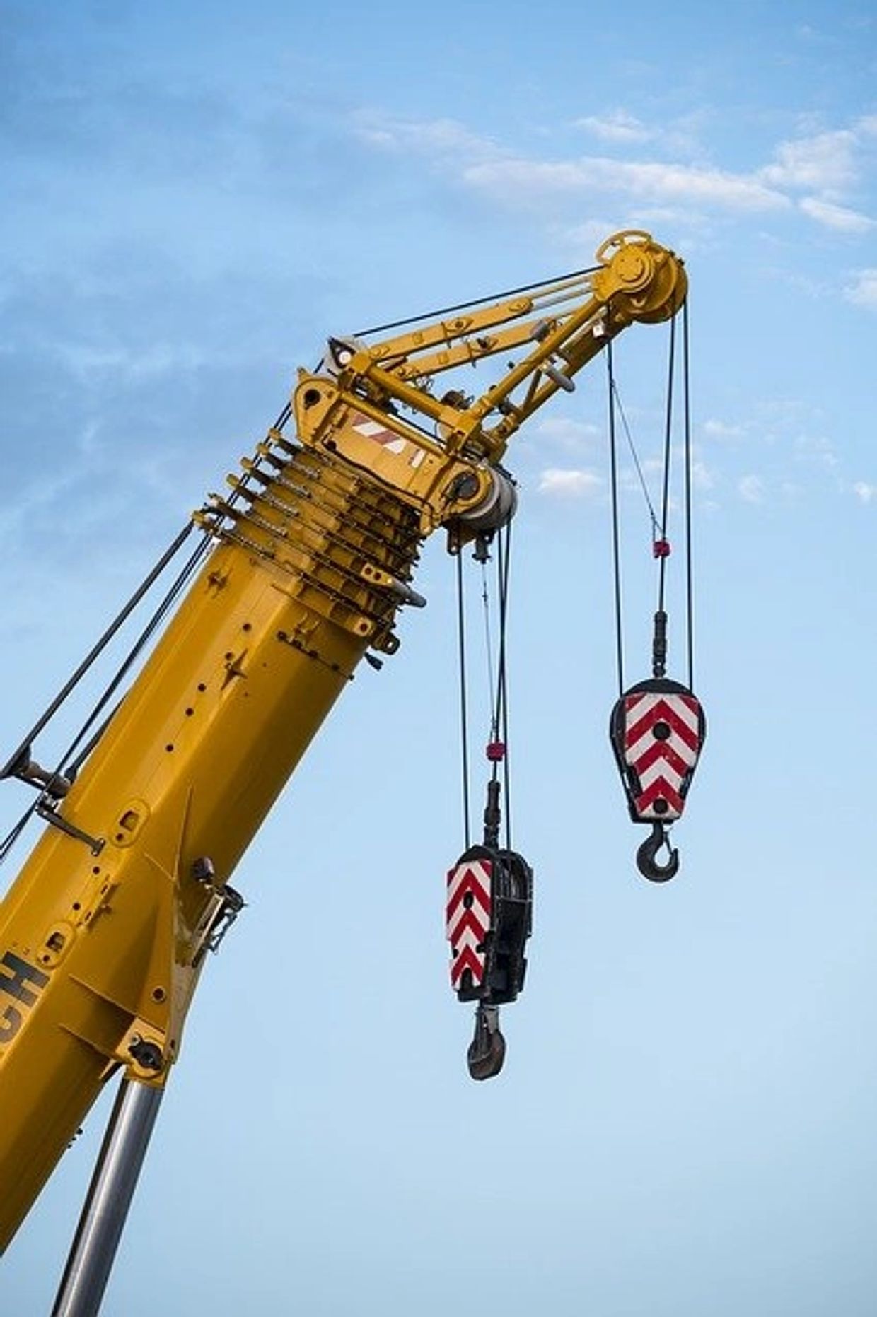 Hooks hanging from crane ready to do heavy lifting.