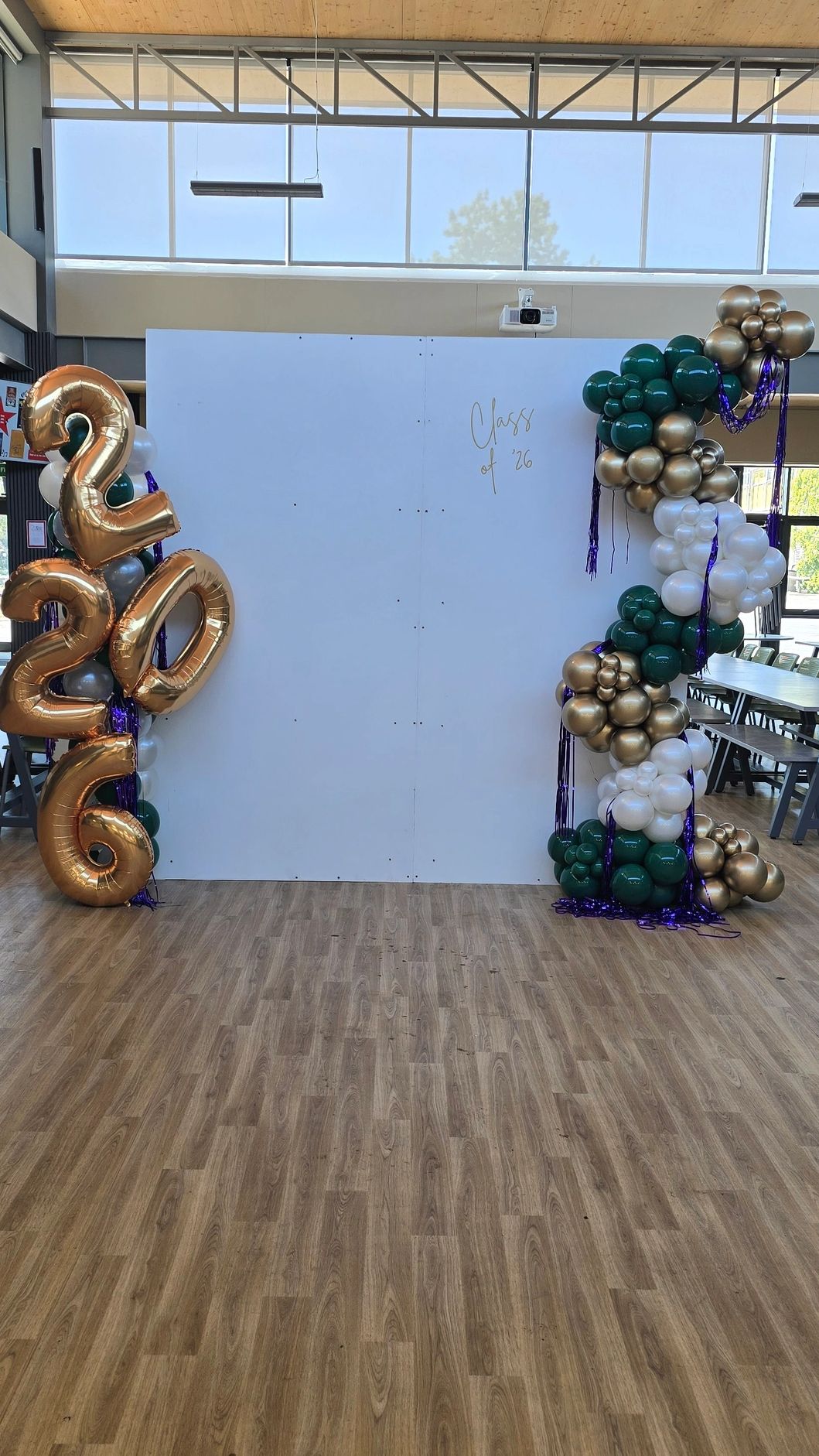Graduation photo backdrop with balloons saying Class of 2026.