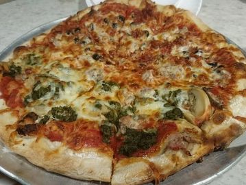 A freshly baked pizza with various toppings on a metal tray.