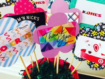 Colorful thank you and brand-themed photo props on sticks.