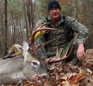 Travis Murray with a deer he hunted