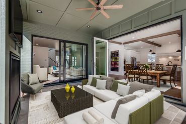 Modern outdoor patio with comfortable seating and open access to the indoor dining area.