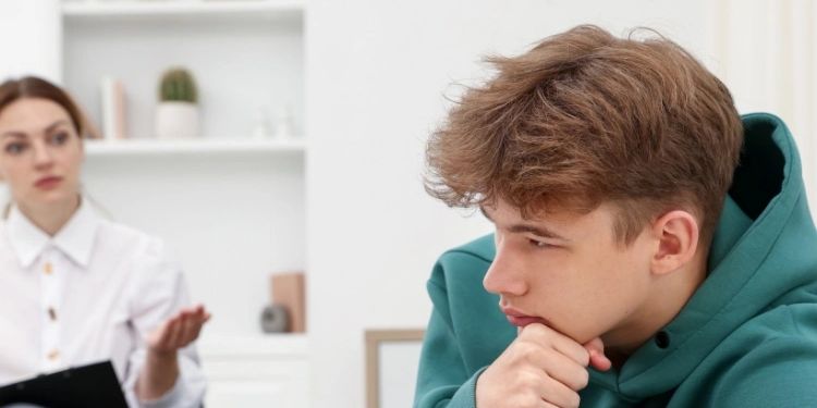 Therapist in Denver helping LBGTQ student with issues in office.