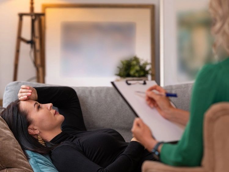 woman laying down on couch getting help with anxiety therapy in Denver CO.