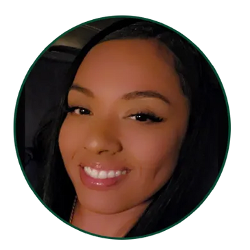 Smiling woman with long black hair and dimples.