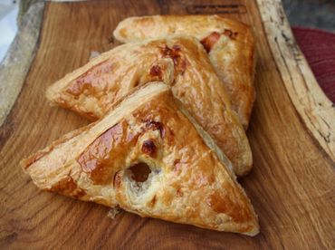 Tany's Turnovers (Empanadas).  Flaky Pastry folded and baked golden. Cinnamon, marionberry.