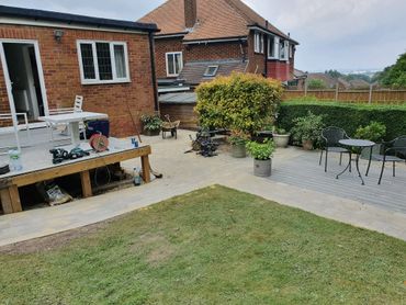 Backyard with patio, lawn, and outdoor seating area.